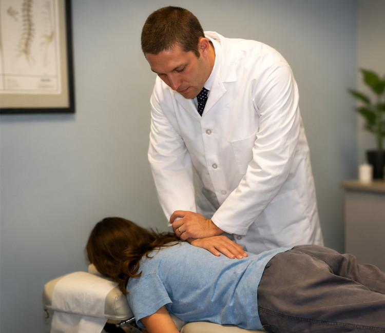 Dr. Henry performing a chiropractic adjustment