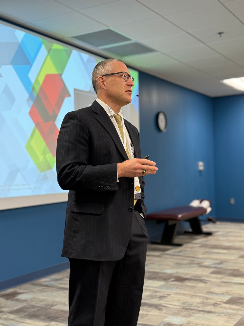 Dr. Luke Henry presenting at a professional conference